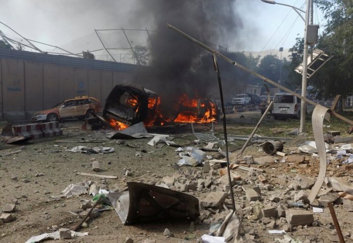 Burned vehicles are seen after a blast at the site of the incident in Kabul, Afghanistan