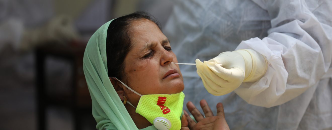 A health worker collects swab samples for COVID-19 tests in Jammu -The Dispatch