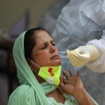 A health worker collects swab samples for COVID-19 tests in Jammu -The Dispatch