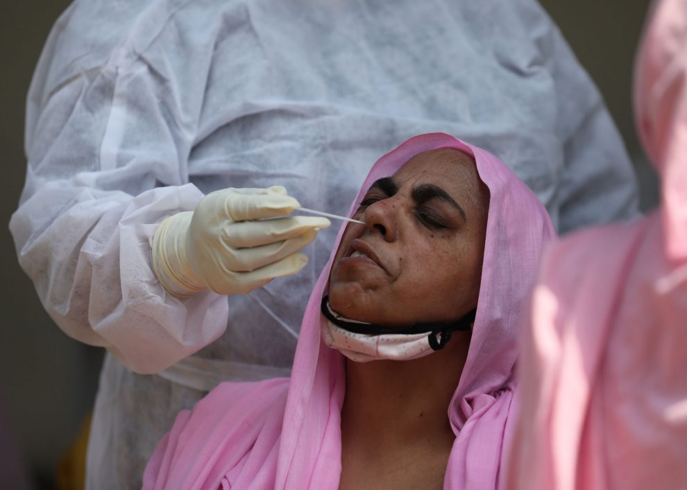 A health worker collects swab samples for COVID-19 tests in Jammu-The Dispatch